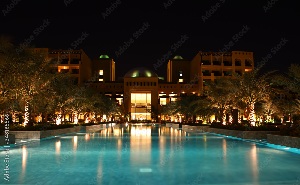 Empty pool at night near the modern hotel Luxury hotel in the evening. No people. Eastern style.