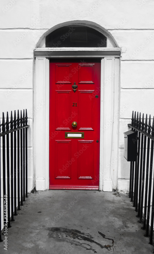 The Victorian houses door.
Colorful picture of a red front door  of a Victorian traditional house i