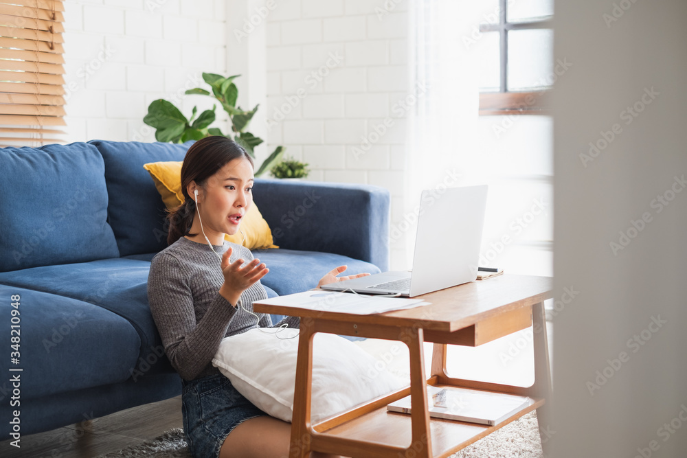 Young Asian businesswoman work at home and virtual video conference meeting with colleagues business