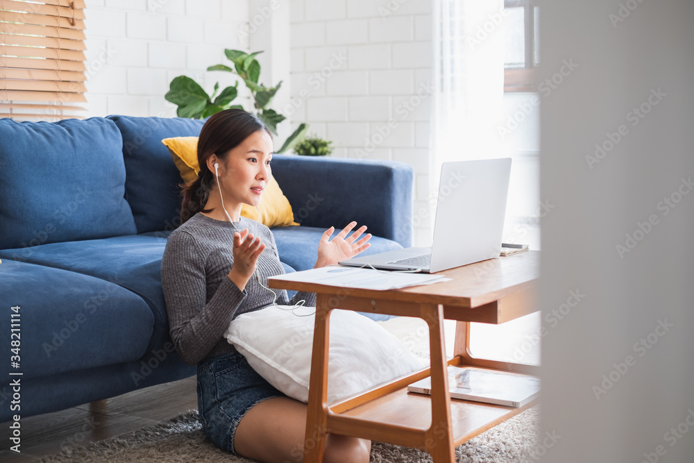 Young Asian businesswoman work at home and virtual video conference meeting with colleagues business