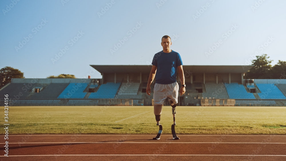 Athletic Disabled Fit Man with Prosthetic Running Blades is Posing During a Training on an Outdoor S