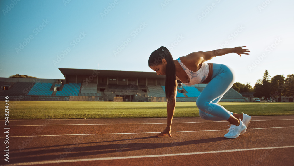 Beautiful Fitness Woman in Light Blue Athletic Top and Leggings is Starting a Sprint Run in an Outdo