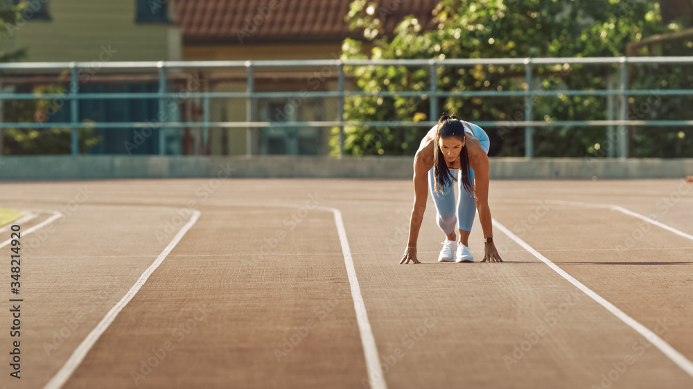 Beautiful Fitness Woman in Light Blue Athletic Top and Leggings is Starting a Sprint Run in an Outdo