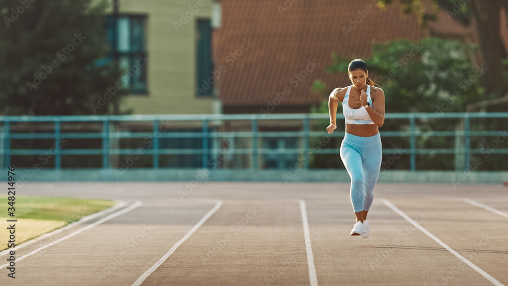 Beautiful Fitness Woman in Light Blue Athletic Top and Leggings is Starting a Sprint Run in an Outdo