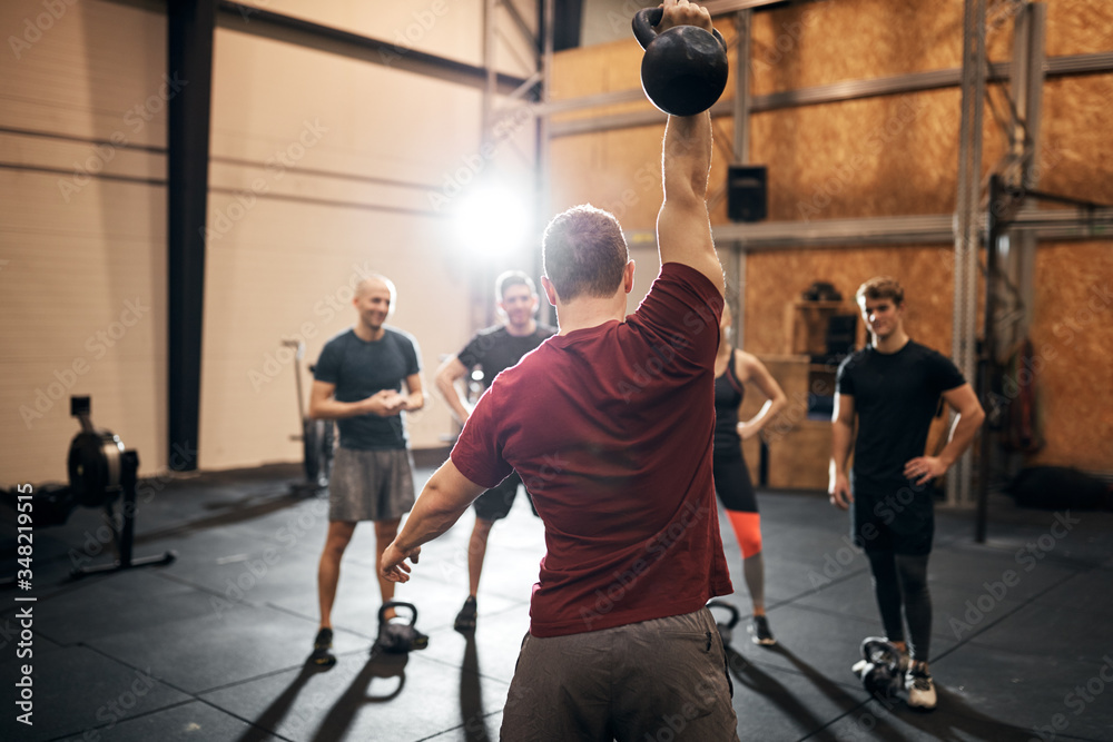 Fitness instructor showing people an exercise at the gym