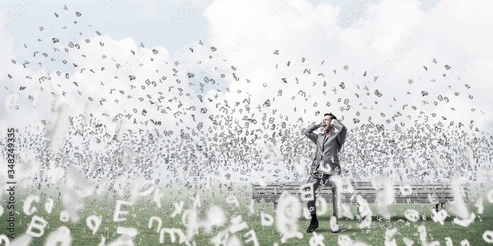 Young man in suit in park dont want to hear anything