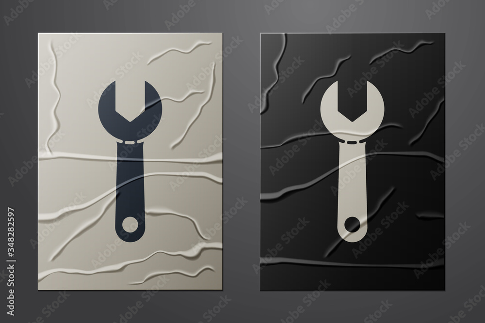 White Wrench spanner icon isolated on crumpled paper background. Paper art style. Vector