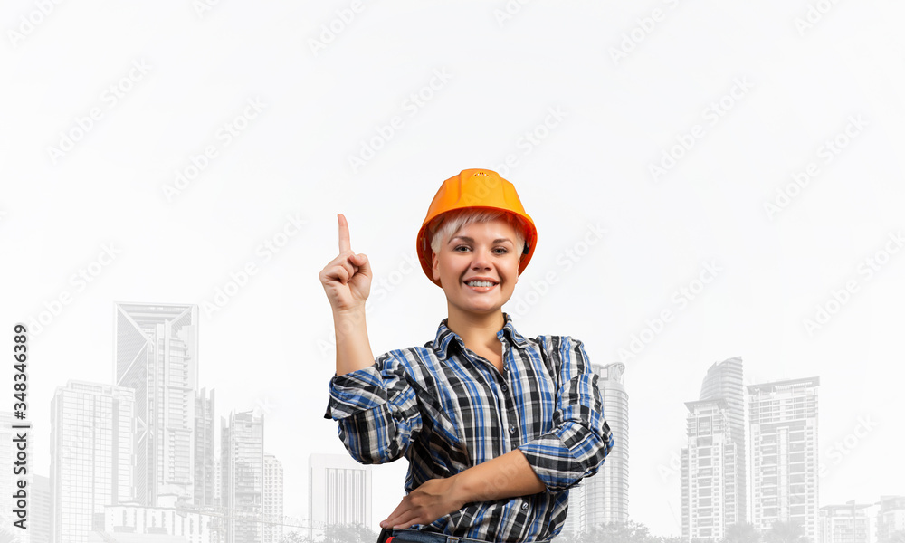 Beautiful female builder in hardhat