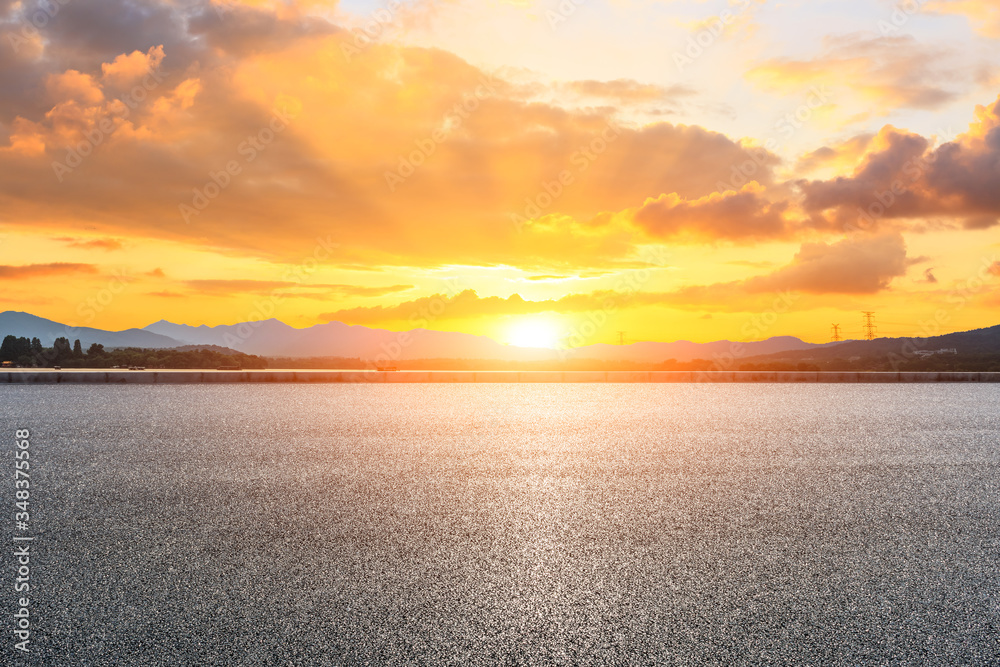 Asphalt road ground and mountain landscape at sunset.