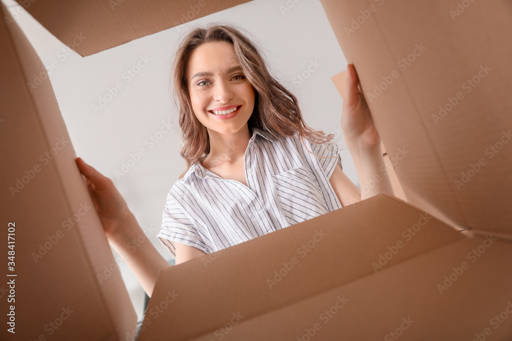 Happy woman with open box, view from inside