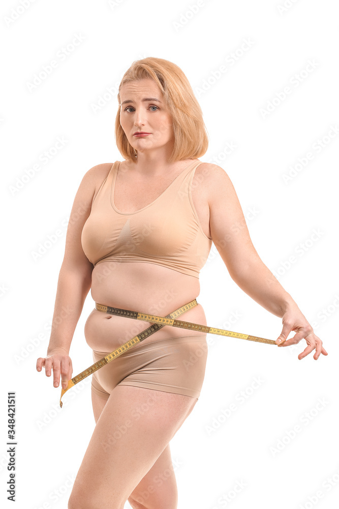 Sad overweight woman with measuring tape on white background. Weight loss concept