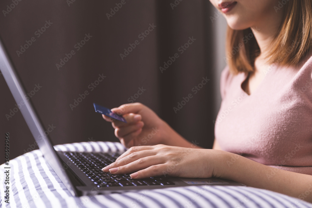 Online shopping concept, Young asian woman using laptop with credit card