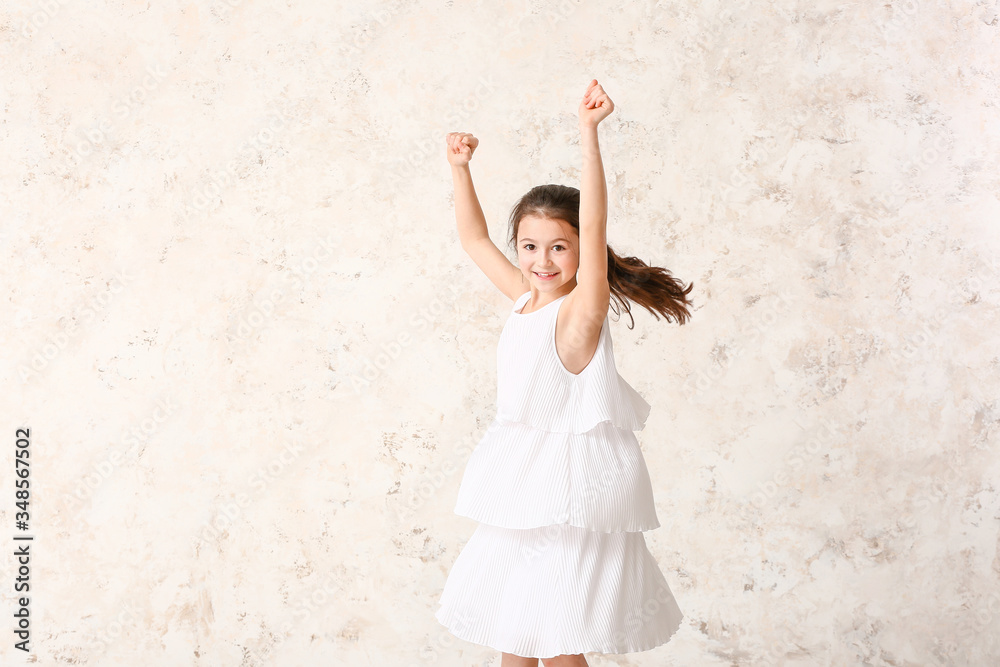 Cute dancing girl on light background