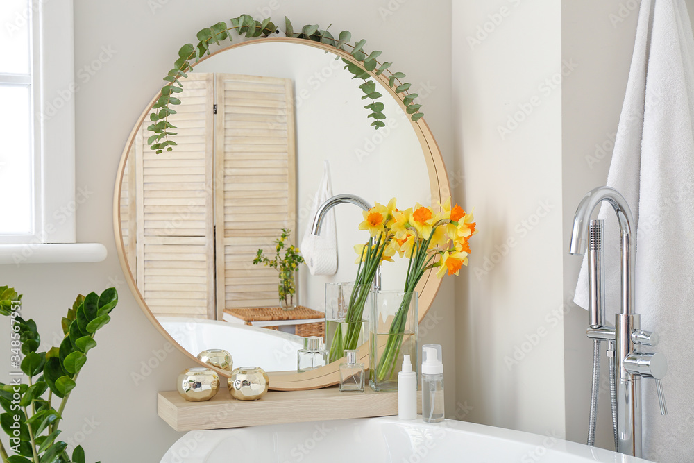 Interior of bathroom with fresh flowers