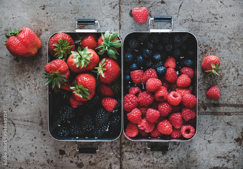 Healthy summer vegan lunch. Flat-lay of fresh seasonal strawberries, raspberries, blueberries and bl