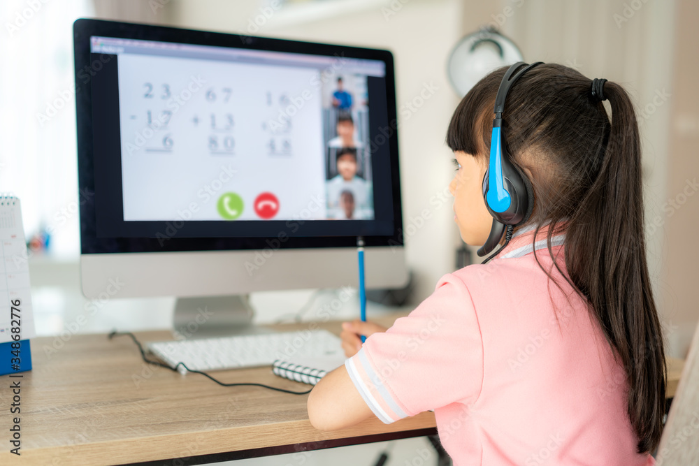 Asian girl student video conference e-learning with teacher and classmates on computer in living roo