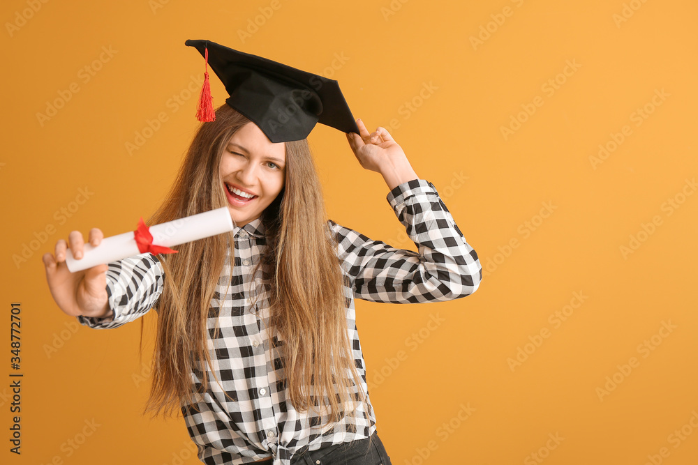 Female graduating student with diploma on color background