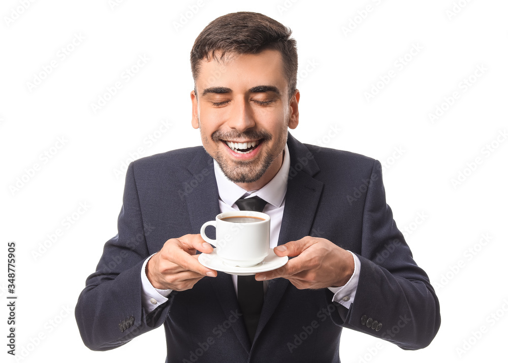 Young businessman with cup of hot coffee on white background