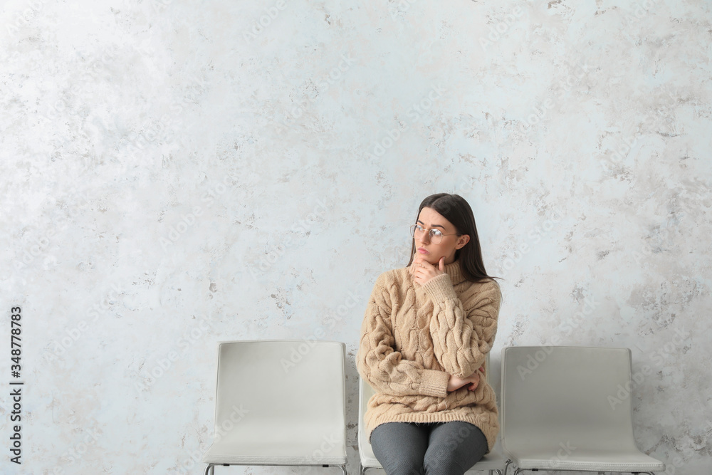 Young woman waiting for her turn indoors