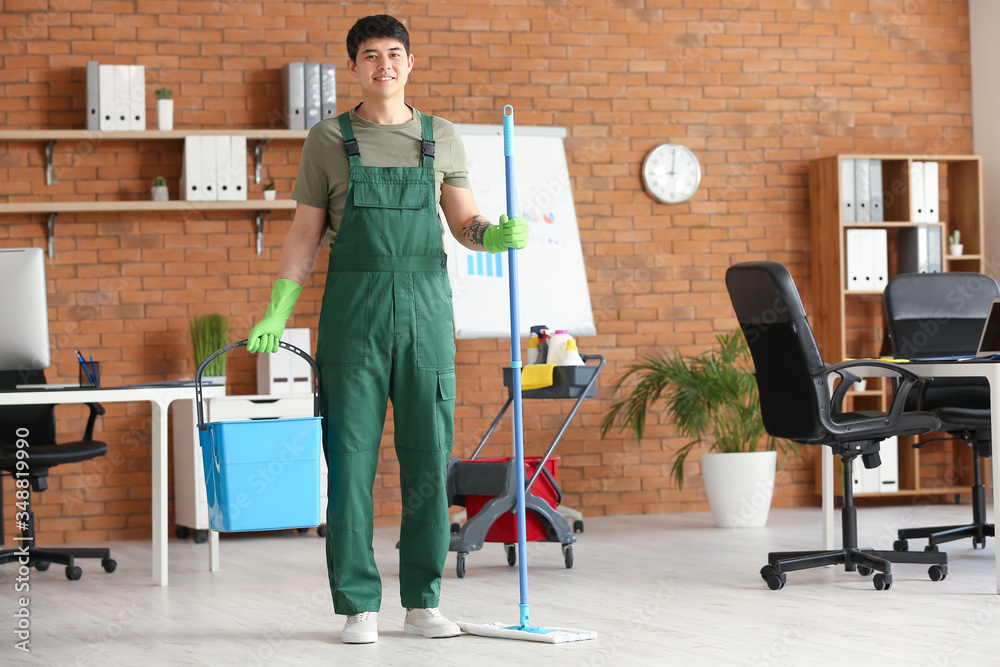 Portrait of male Asian janitor in office