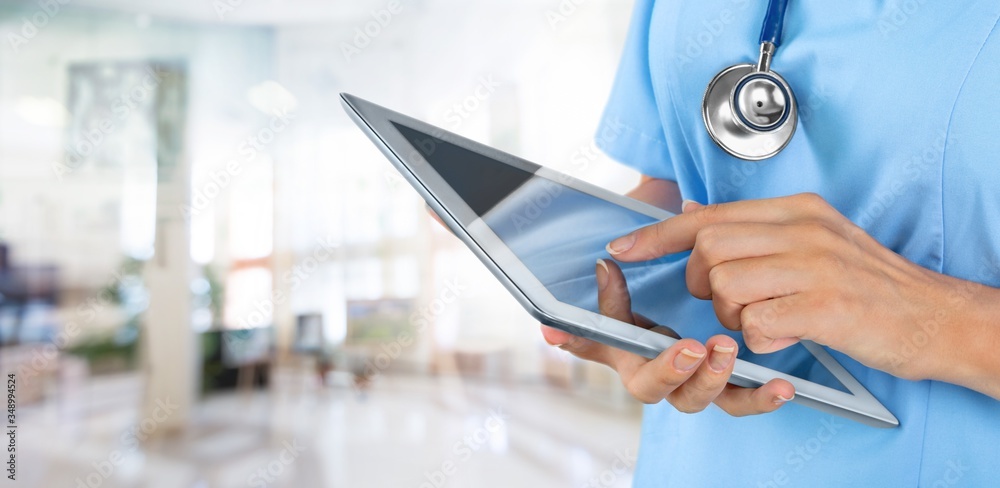 Doctor at hospital working with tablet pc