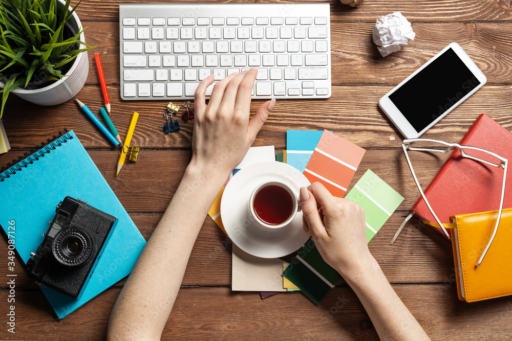 Woman designer typing on keyboard