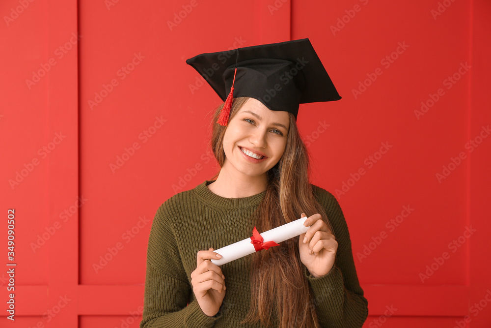 Female graduating student with diploma on color background