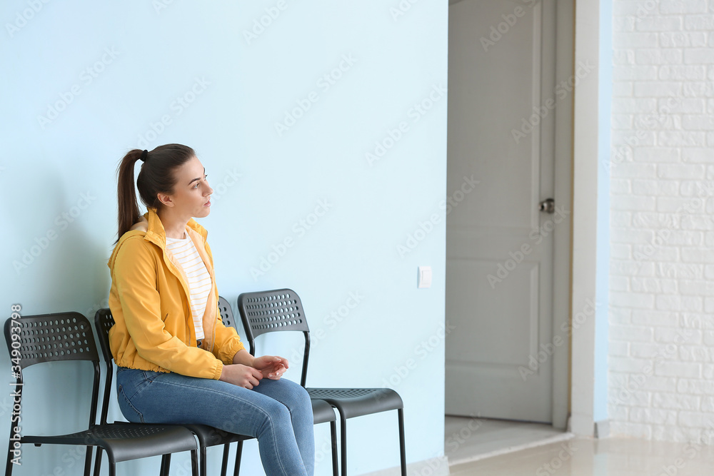 Young woman waiting for her turn indoors