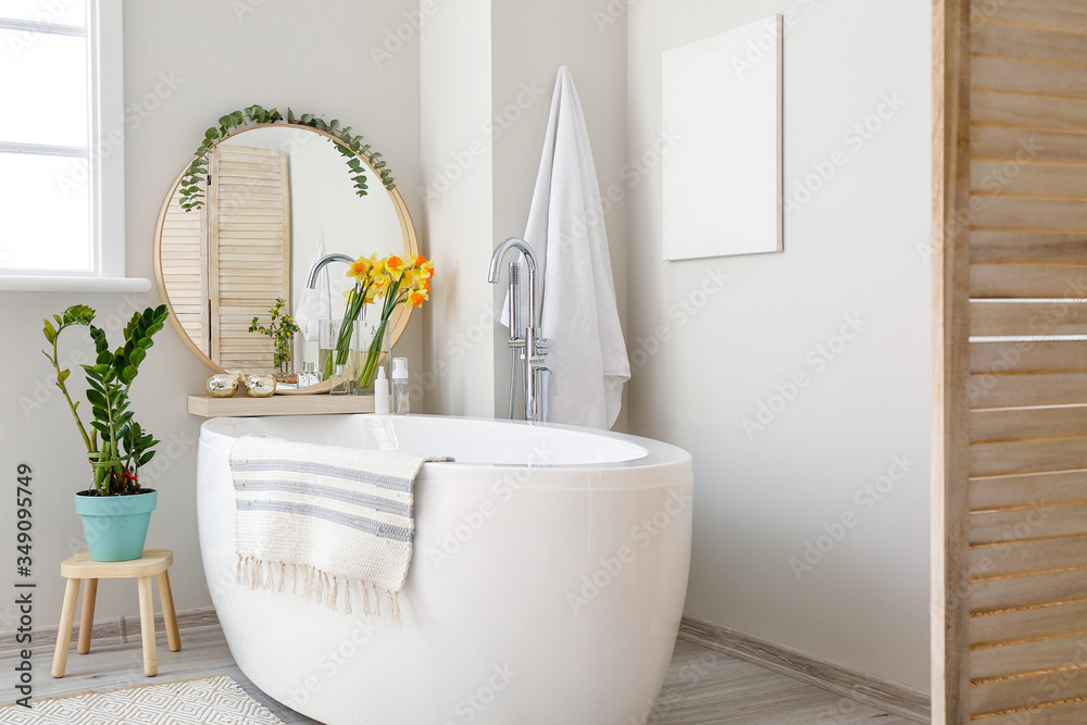 Interior of bathroom with fresh flowers