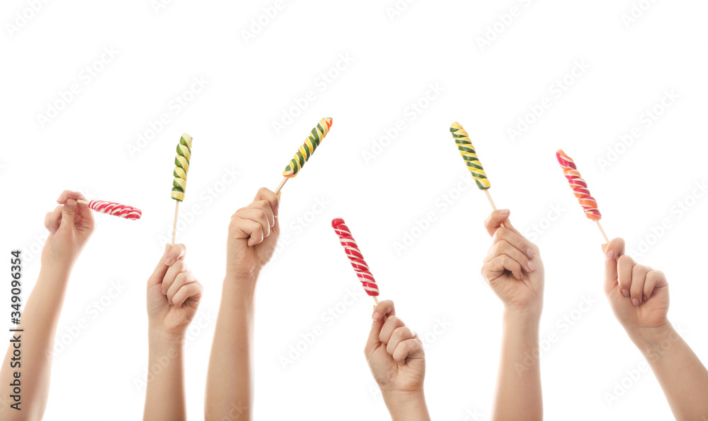 Hands with sweet lollipops on white background