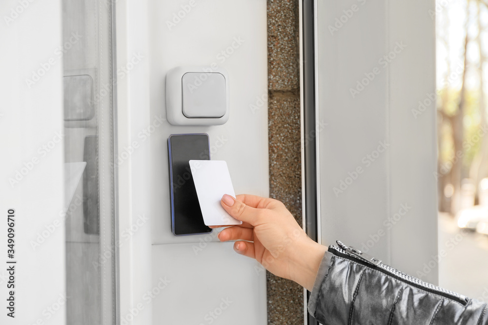 Woman opening door with security card from the outside