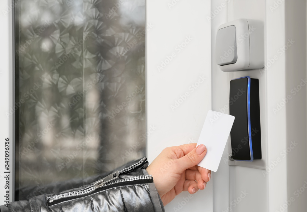 Woman opening door with security card from the outside