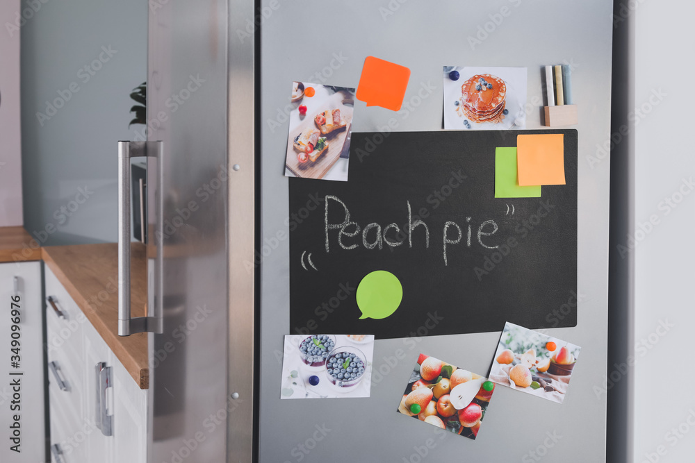 Chalkboard on door of modern refrigerator in kitchen