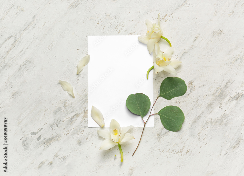 Composition with blank card and flowers on light background