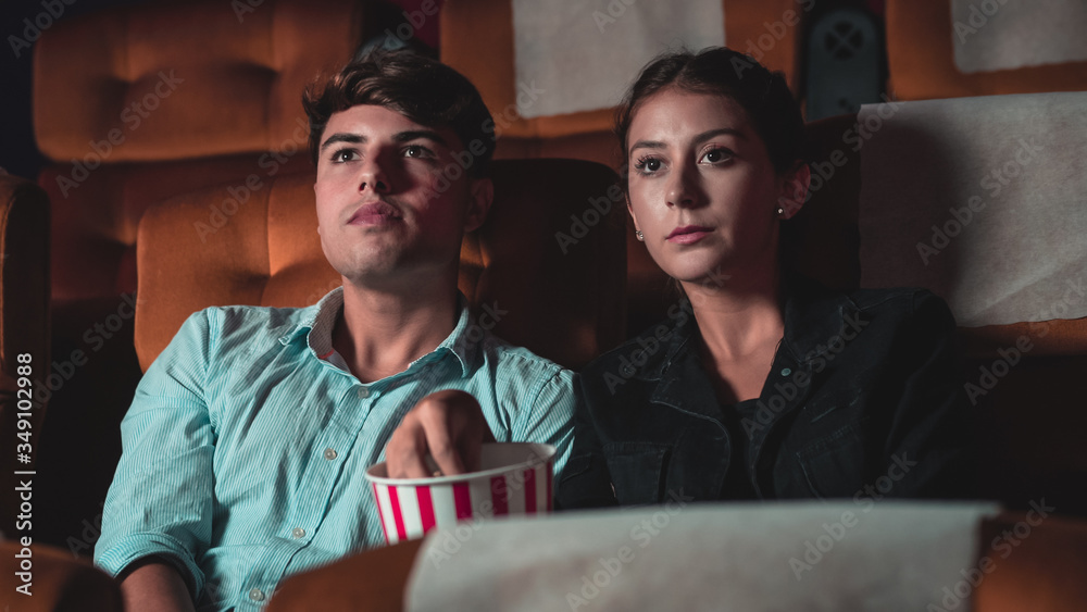 People audience watching movie in the movie theater cinema. Group recreation activity and entertainm