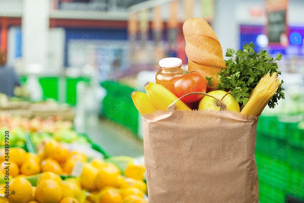 Eco shopping bag with vegetables on a blur market background