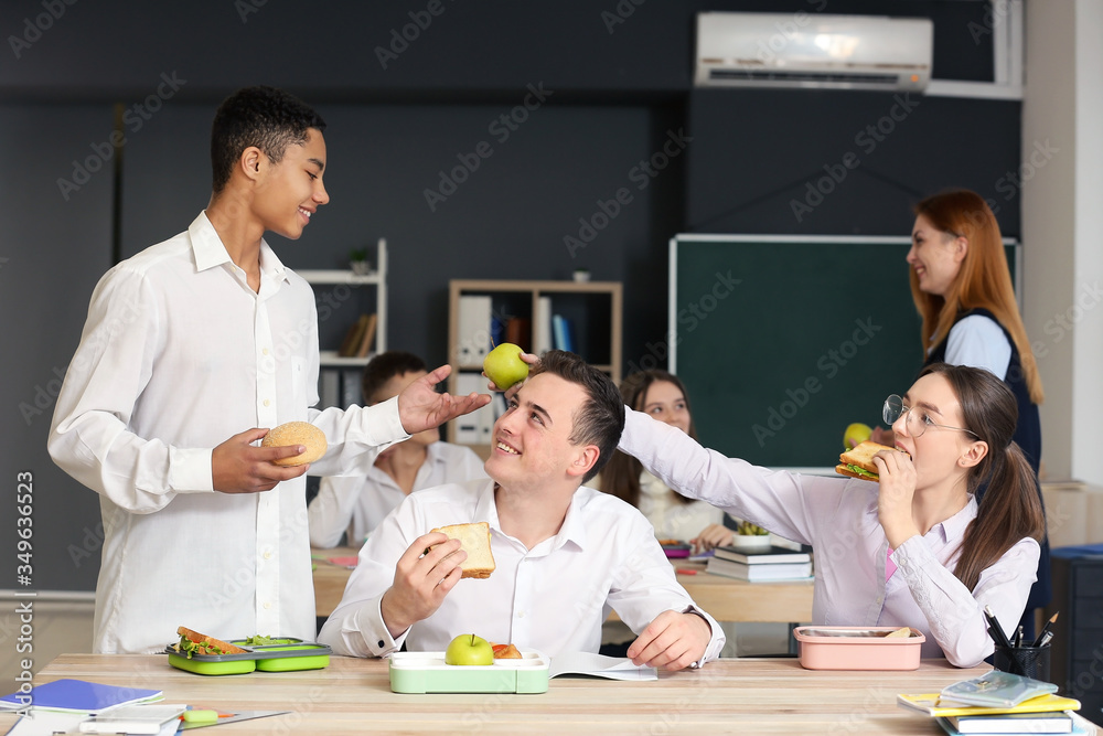 Pupils having lunch in classroom