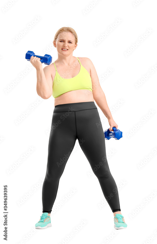 Woman with excess weight training on white background