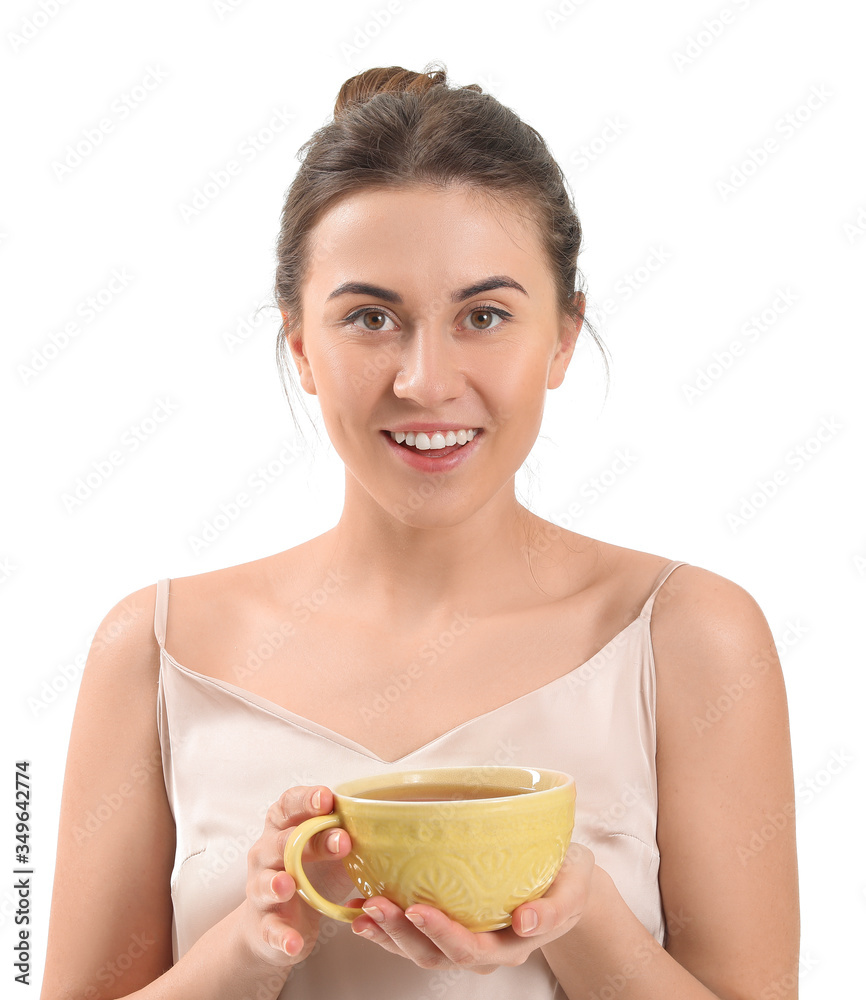 Young woman with cup of tea on white background