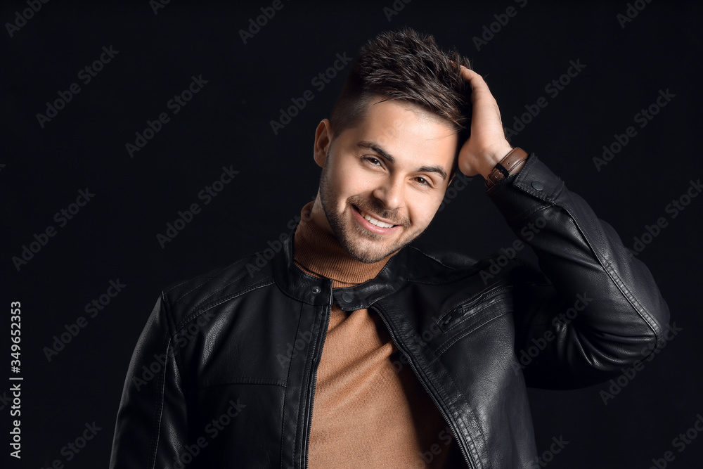 Handsome man with stylish hairdo on dark background