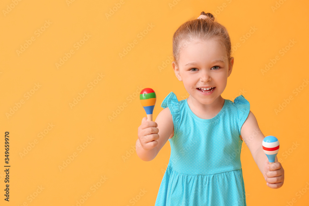 Little girl with toy on color background