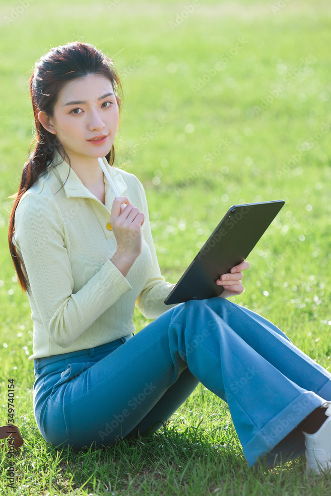 Asian girl sitting on the grass