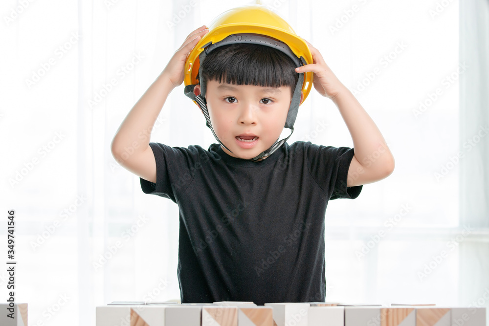 Asian little boy playing with building blocks