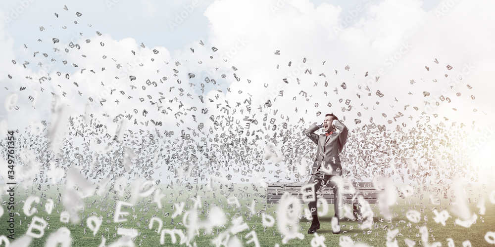 Young man in suit in park dont want to hear anything