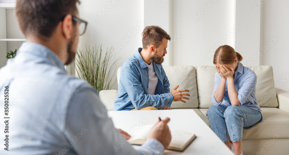 Couple visiting psychologist in modern clinic.