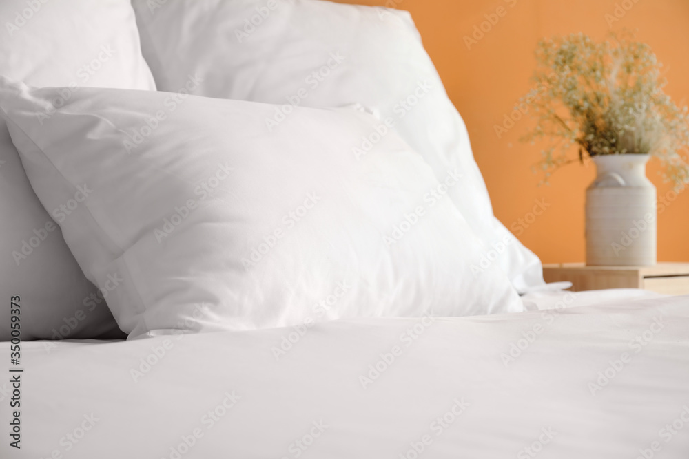 Big comfortable bed with clean linen in room