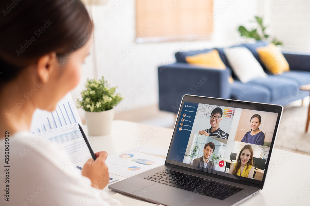 Young Asian businesswoman work at home and virtual video conference meeting with colleagues business