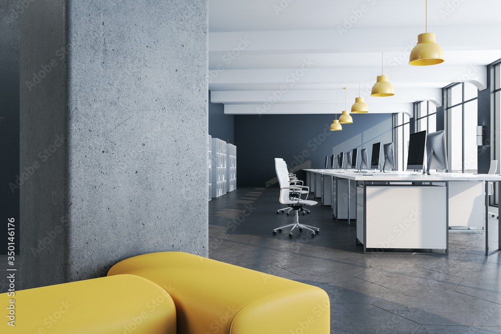 Modern coworking office interior with computers and shelves with documents.