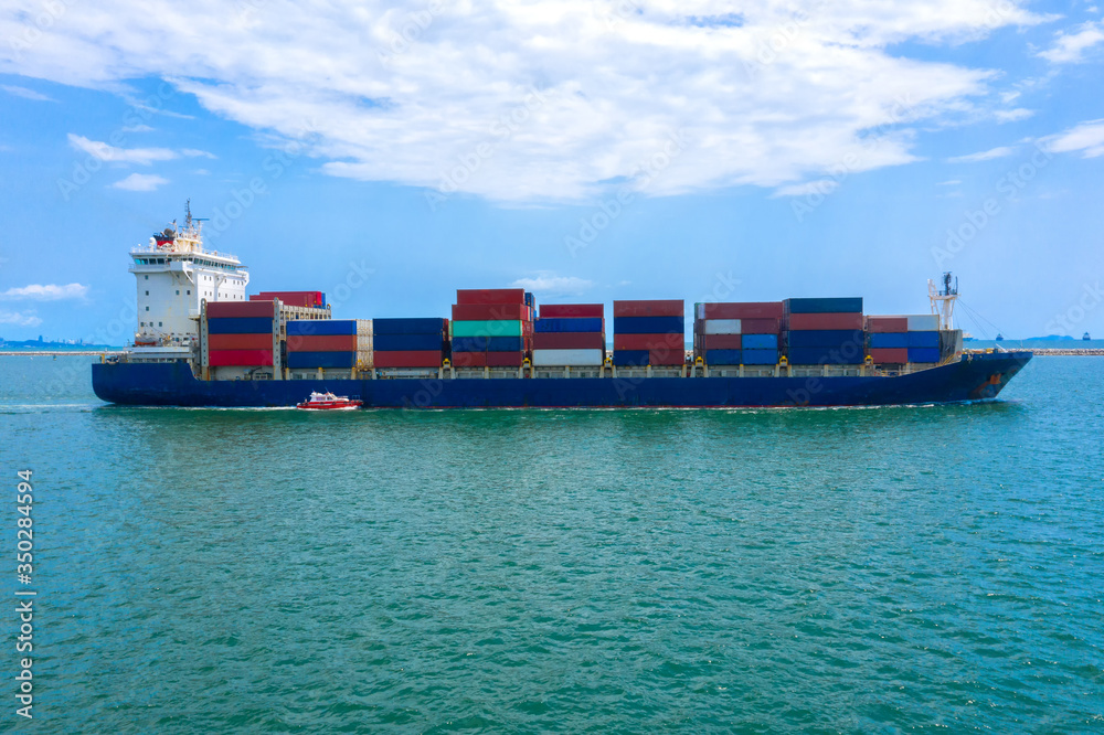 Container , container ship in export and import business and logistics. Shipping cargo to harbor by 