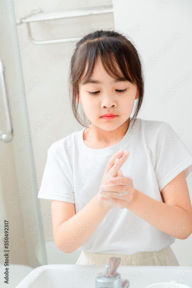 Asian little girl washing hands